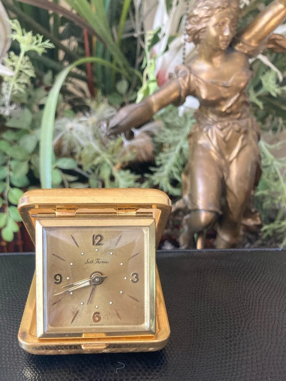 Classic mid-century Seth Thomas folding travel alarm clock in gold-tone texture